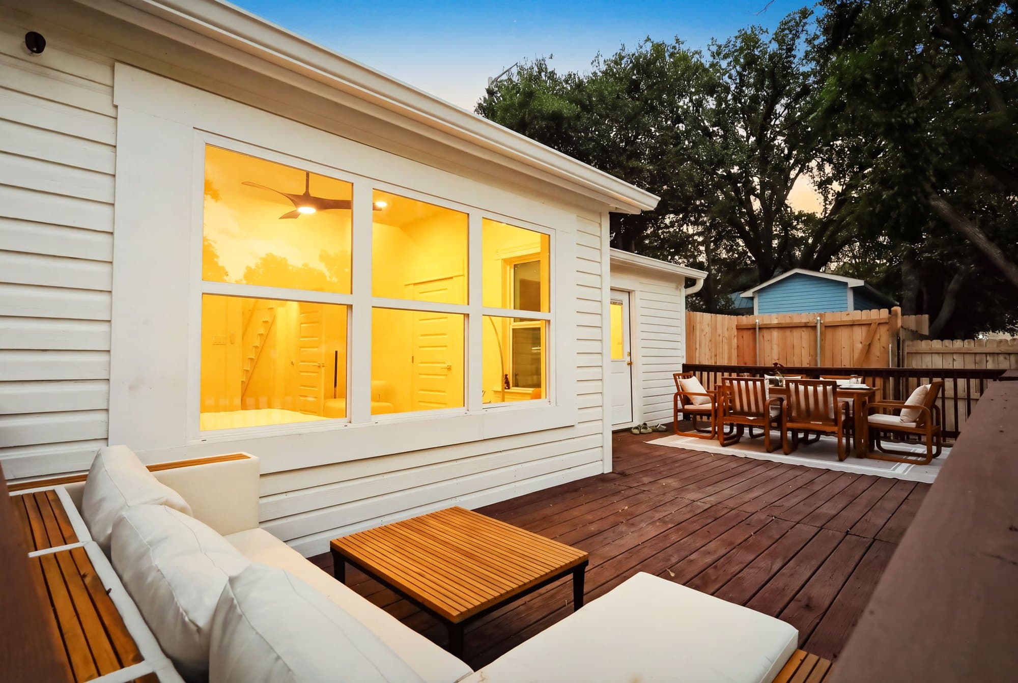 Rear deck seating with warm light through the windows in the evening