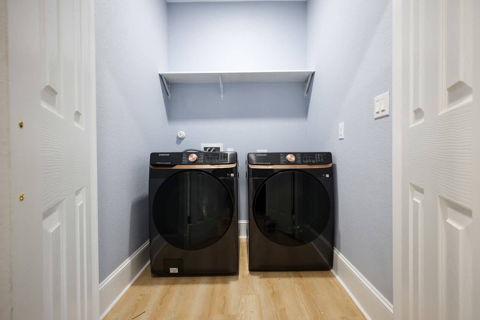Full-size washer and dryer set into a finished laundry closet